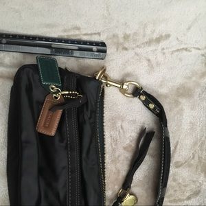 Coach handbag satin like material with charms.